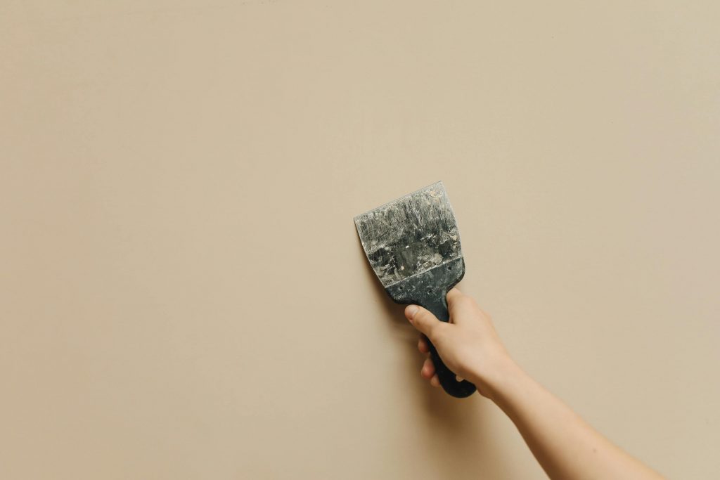 pexels-photo-5583128-5583128 Hand with Trowel Renovating Wall