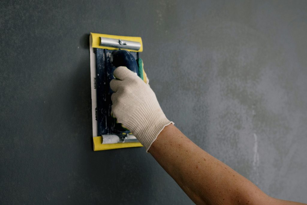 pexels-photo-5691613-5691613-1 Crop man scarpering gray wall in flat